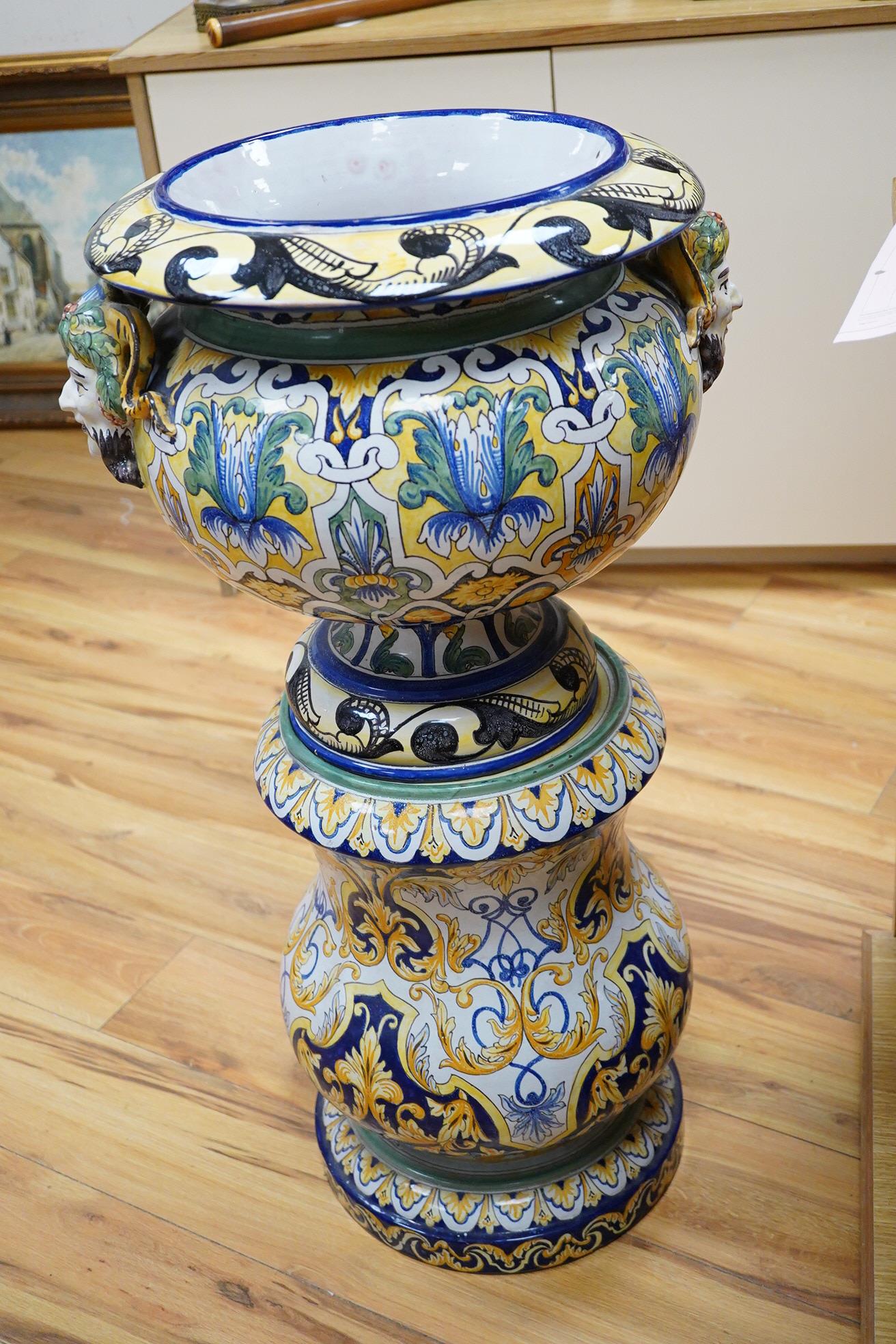 A tall decorative French faience pottery jardiniere with Bacchus mask mounts and a similar associated stand